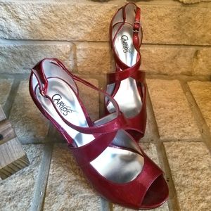 Shiny Red peep toe pumps with crisscross straps. 4.5” heel